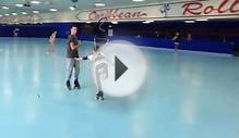 young guy figure skating with handheld jump harness